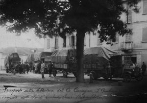 A black and white image of a series of trucks transporting the Cavagna Sanguiliani Collection