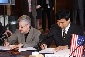 Professor Paula Kaufman and Dr. Zhan Furui sign an agreement establishing a cooperative and cultural exchange between American and Chinese librarians.