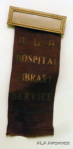 Pin and brown ribbon worn by hospital librarians instead of bronze ALA pins.