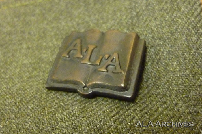 Final version of the official librarian pin used on uniforms.