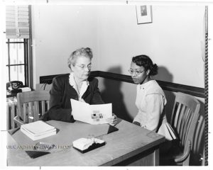Rose B. Phelps advising library student Norma Miller Ponisett. 