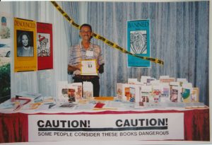 Man standing at a banned books display