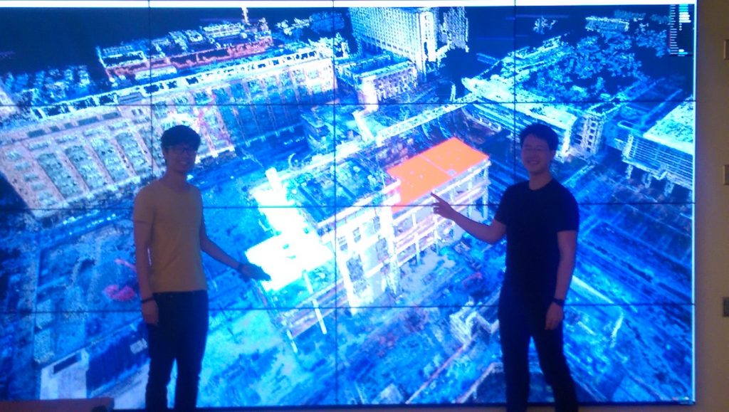 The Visualization Wall with two students standing in front of it