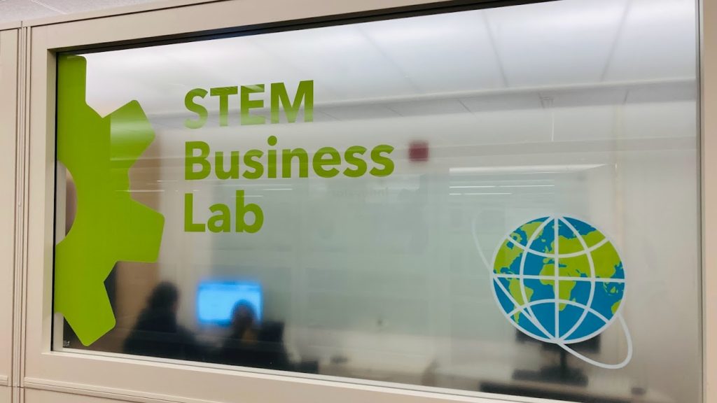 STEM Business Lab Sign on a window with computer workstation in the background.