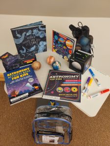Contents of Astronomy backpack placed on table.