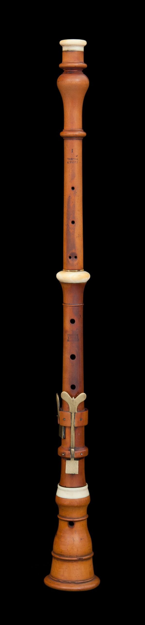 Wood and ivory instrument with finger holes. In the bagpipe family.