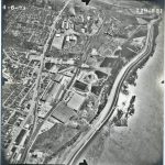 Black and white aerial photo of town along Mississippi River