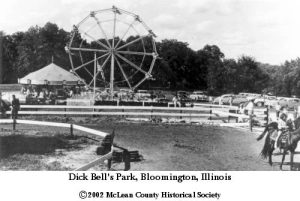 Amusement park with a horse racing track in the foreground and a Ferris wheel and carousel in the background