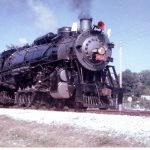 Color photo of a steam locomotive moving down the track