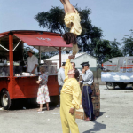 Astrid Schlichting in a hand to handstand, onehanded, balancing on her father's upheld hand