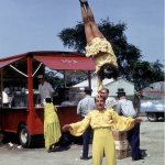 Astrid Schlichting performs a one-handed handstand on her father Ernst's head