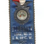 Beautiful silk ribbon with badge, from a member of the Fidelity Lodge No. 54 of the International Association of Car Workers. Front side is Blue silk with silver lettering, back side is black silk with silver lettering and designs and says Newark, New Jersey at the top and IN MEMORIAM.