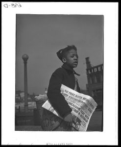 Chicago, Illinois. Newsboy selling the Chicago Defender, a leading Negro newspaper