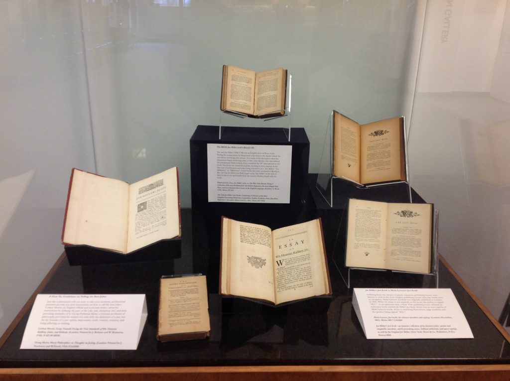 A display case with five books.