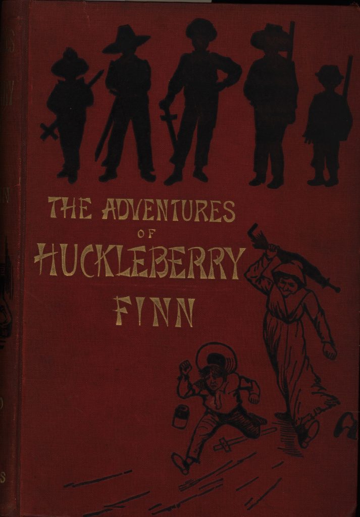 The front cover of The Adventures of Huckleberry Finn. It is red with black silhouettes and gold lettering.