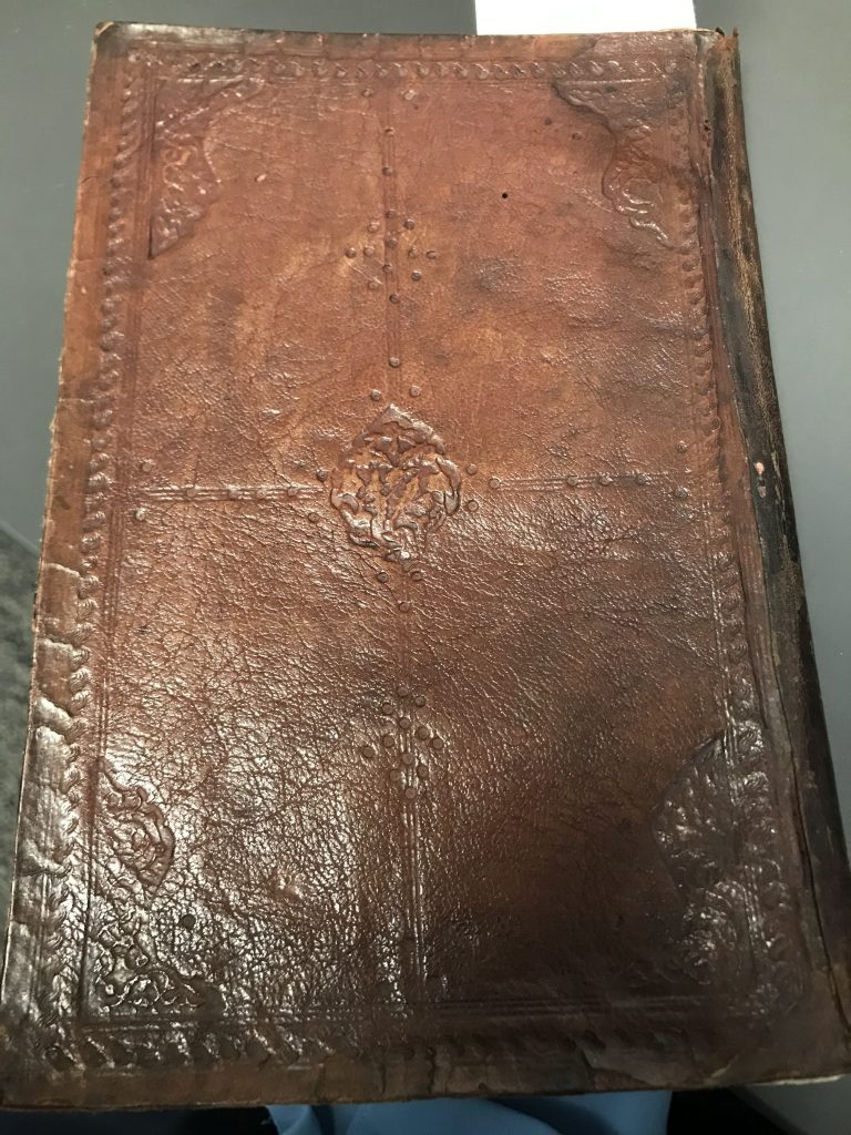 A book with a brown leather cover