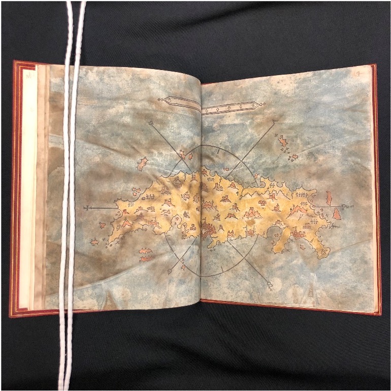 Book open to hand-colored map.