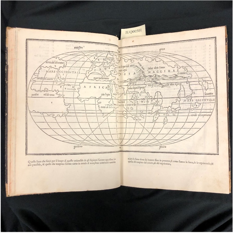 Book open to an early map of the world.