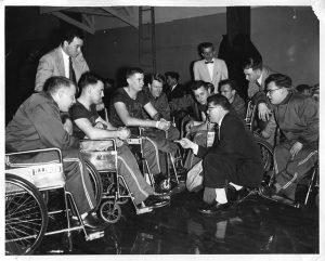 Timothy Nugent coaches players during a 1955 game