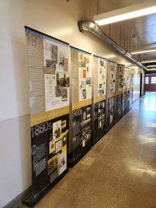 Building hallway with eight exhibit panels.